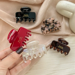 Five elegant acetate hair claw clips in assorted colors with Barrette La France gold lettering