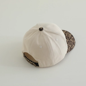 Detail view of the beige baseball cap showing leopard print brim and adjustable back strap