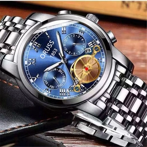 Detail view of silver men's watch with blue sunray dial and dual calendar windows