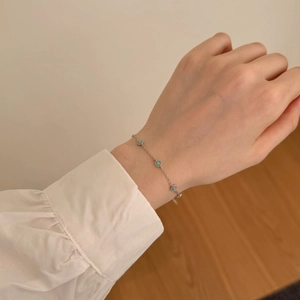 Detailed close-up of a delicate S925 silver bracelet featuring three round turquoise stones