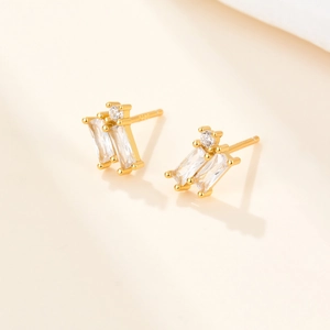 Detailed macro view of S925 sterling silver stamp and sparkling zircon geometric earrings