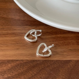 Elegant 925 sterling silver heart-shaped hoop earrings on a minimalist wooden background