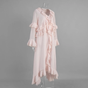 Detail of light pink dress with ruffled V-neckline and tiered chiffon textures