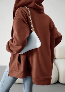 Detail of brown fleece oversized hoodie paired with light blue gold chain handbag