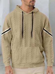 Detail of khaki cable-knit hoodie showing fabric texture and drawstring hood