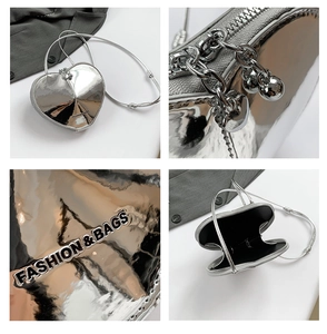 Detailansicht einer silbernen herzförmigen Tasche mit Metallreißverschluss und Innenraum