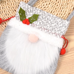 Detail of Gnome Christmas gift bag with grey felt fabric and red drawstring closure