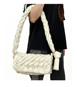 On-body shot of white woven shoulder bag with knotted strap and textured PU leather