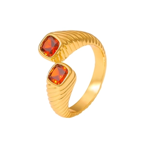 Vintage gold geometric ring featuring dual orange-red zircon stones and ribbed band texture