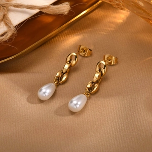 Elegant gold chain drop earrings with white teardrop pearls on silk background