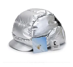 Detail showing metallic silver earflap hat with quilted patterns and insulation samples