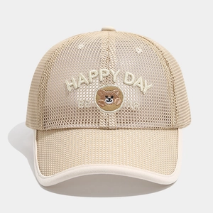 Detail of breathable mesh texture and Happy Bear embroidery on the beige kids baseball cap
