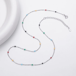 Macro detail of S925 sterling silver chain with vibrant colorful beads and lobster clasp