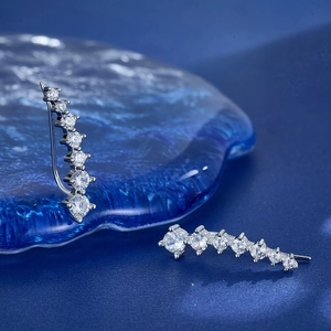 Detailed macro view of S925 silver ear cuff with gradient clear cubic zirconia stones