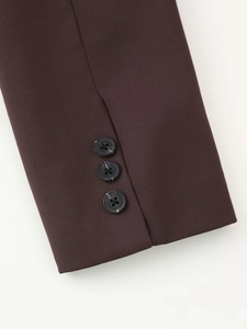 Detailed view of dark brown blazer cuffs featuring three neatly arranged buttons