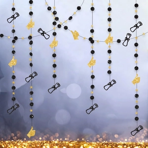 Detail of graduation party hanging swirls with black glitter scrolls and gold stars
