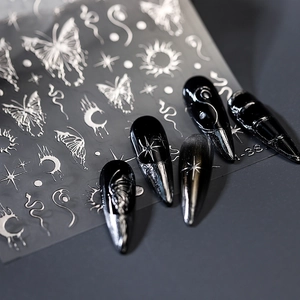 Silver 3D embossed nail stickers with metallic butterfly and snake designs on black nails