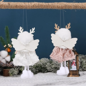Handmade Christmas angel dolls with lace wings and plush details hanging on pine branches