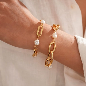 18k gold plated chain bracelet with baroque pearls shown on a woman's wrist