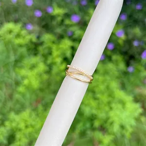 Close-up of three-layer 18K gold-plated interlocking ring with paved zircons