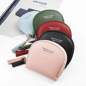 Shell-shaped faux leather coin purses with tassels in five colors on white background