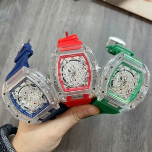 Three colorful tonneau-shaped transparent watches with skeleton dials and rubber straps