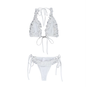 Detailed view of white two-piece bikini with ruffle trim and side-tie bikini bottoms