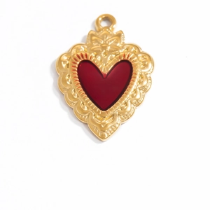 Detail shot of a gothic red heart pendant with 18K gold plating and polished finish