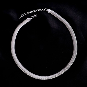 Silver snake chain necklace in stainless steel with lobster clasp on black velvet