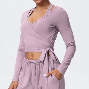 Detail of cross-wrap tie waist on lilac yoga top with soft brushed fabric texture