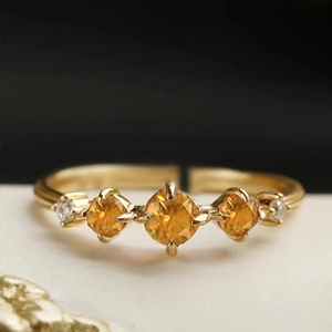Macro shot of gold adjustable ring with orange stones and tiny zircon accents