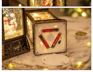 Detail of Christmas snow globe lantern base showing the AAA battery compartment and switch