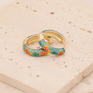 Retro gold earrings with colorful enamel floral patterns on elegant textured stone