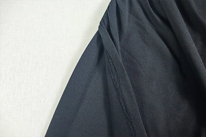 Detail of black fabric texture with fine stitching on an elegant slim-fit dress