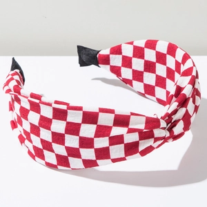 Detailed view of red and white checkerboard knot headband with soft fabric texture