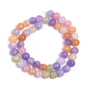 Detail of colorful crackle glass beads in purple, pink and blue for DIY jewelry crafts