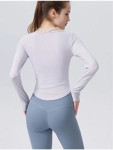 Rear view showing the slim fit cross-neck lavender yoga top and blue leggings