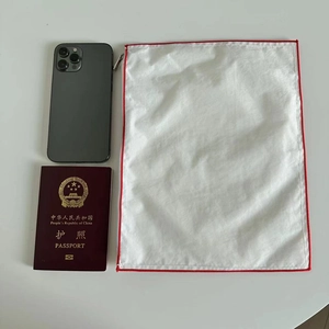 Detail of white nylon organizer bag with red stitching zipper and compact portable size