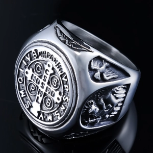 Macro detail of silver Saint Benedict medal ring with vintage embossed religious symbols
