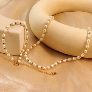 Vintage baroque pearl necklace with gold beads on beige silk background for elegant styling