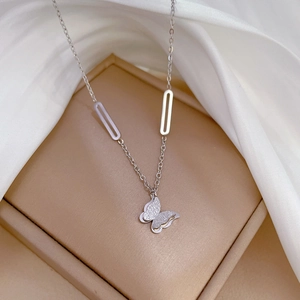 Detail of silver titanium necklace featuring crystal butterfly pendant and geometric chain links