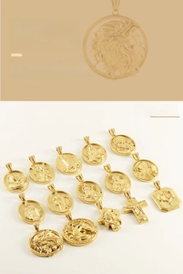 Macro detail of 3D embossed gold religious pendants featuring crosses and animal motifs