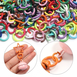 Colorful metal jump rings with star-shaped clasps and small pink bells for DIY jewelry