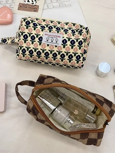 Corduroy makeup bags in floral and checkerboard patterns with ample storage capacity