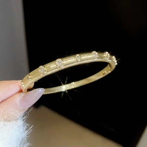 Detailed close-up of 18k gold plated bangle with sparkling cubic zirconia inlays