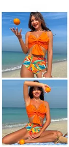 Close-up of bright orange bikini top with oversized bow and floral high-waist bottoms