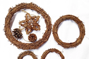 Detailed view of natural rattan wreaths and pine cones for Christmas DIY craft decor