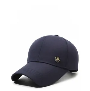 Detailed close-up of dark blue cotton baseball cap with a golden metal fashion shield logo