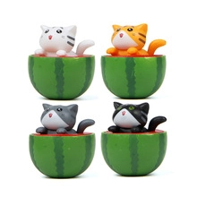 Set of four cute miniature cats sitting in watermelons for garden landscape decor
