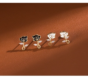 Macro detail of French retro rose stud earrings with enamel petals and zircon inlay